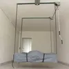 A garage or storage space with a ceiling-mounted lift system holding a covered product. Produktbild-Vorschau
