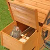 A chicken is inside a wooden chicken coop with the lid open. Podgląd zdjęcia produktu