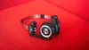 A pair of Koss Porta Pro headphones rests on a textured red surface. Produktbild-Vorschau