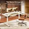 A modern home office setup with a white standing desk, two monitors, a chair, and decorative elements. Produktbild-Vorschau