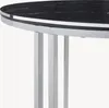 A close-up view of the edge of a round table with a black marble top and silver legs. Produktbild-Vorschau