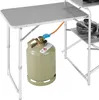 A close-up view of a camping kitchen setup, focusing on a gas cylinder connected to the cooking unit. Produktbild-Vorschau