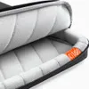Close-up view of the interior of a black laptop bag, showing its padded lining and a small orange tag with text. Produktbild-Vorschau