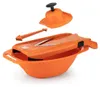An orange vegetable slicer with its accessories, disassembled, on a white background. Produktbild-Vorschau