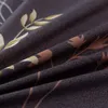 A close-up view of a dark gray fabric with a floral pattern in gold, brown, and white. Anteprima dell’immagine prodotto