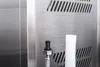 Close-up of a stainless steel surface with two connectors and a ribbed white tube. Podgląd zdjęcia produktu