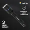 A black Varta flashlight is displayed against a dark, circuit-board-like background. Text and logos are overlaid on the image. Produktbild-Vorschau