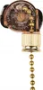 A close-up studio shot of a gold and transparent pull chain switch for a ceiling fan or light. Podgląd zdjęcia produktu