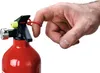 A close-up shot of a hand using a red fire extinguisher. Produktbild-Vorschau