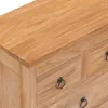 Close-up view of a wooden dresser with ring handles. Voir les images du produit