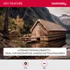 A scenic landscape with a wooden boathouse on a lake, mountains in the background, and text overlays describing a camera lens feature. Voir les images du produit