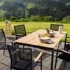 An outdoor dining set on a wooden deck with a scenic mountain and forest background. Náhled obrázku produktu