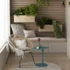 A cozy balcony seating area with a chair, bench, plants, and a small table. Produktbild-Vorschau