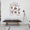 A wall-mounted photo frame collage with the word "FAMILY" above it, displayed in a modern living room setting with a bench and a floor lamp. Produktbild-Vorschau