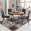 A round dining table with four chairs in a dining room setting. Produktbild-Vorschau