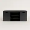 A black shoe cabinet with a padded seat on top, set against a plain white background. Náhľad obrázku produktu