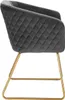 A side view of a dark gray velvet armchair with gold metal legs. Produktbild-Vorschau