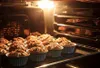 Muffins baking in an oven. Produktbild-Vorschau