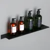 Four pump bottles of various sizes and colors are displayed on a black shelf against a gray wall. Náhľad obrázku produktu