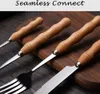 Close-up of cutlery with wooden handles on a wooden surface. Voir les images du produit