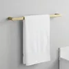 A white towel hanging on a gold towel rack mounted on a light gray wall. Anteprima dell’immagine prodotto