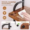 Close-up of a shelf with water spilled on it and a hand wiping it with a cloth. Below are two inset images showing product features: 'Kippschutz' (anti-tip device) and 'Untermate' (underlay). Text describes features like 'Robuste, langlebige Konstruktion'  Produktbild-Vorschau