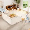A woman is sitting on a couch in a living room, using a laptop, while two dogs play inside a white playpen. A young child is also present near the playpen. Podgląd zdjęcia produktu