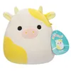 A plush toy cow with yellow markings and a tag. Podgląd zdjęcia produktu