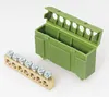 A green plastic terminal block housing and a brass terminal block with screws are placed on a white background. Produktbild-Vorschau