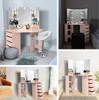 Collage of four images showing a pink vanity table with LED lights and mirrors in different settings. Voir les images du produit
