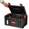 A person's hand is opening a black tool box with red latches. Náhled obrázku produktu