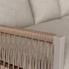 Close-up of the armrest of a sofa, showing the woven rope detail and a metal frame. Produktbild-Vorschau