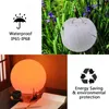 A collage of images showing a decorative LED ball light in different settings, including outdoors in nature and indoors on a desk. Podgląd zdjęcia produktu