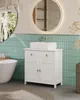 A modern bathroom with a white vanity, sink, and bathtub. Voir les images du produit