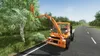 A truck with a tree trimming attachment is shown on the side of a road, trimming branches from a tree. Produktbild-Vorschau
