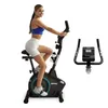 A woman is riding a stationary bike. A separate image of the handlebars and console is shown to the right.