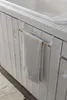 A towel rack attached to a cabinet door, with a towel hanging on it. Náhľad obrázku produktu