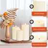 Three LED candles of varying heights are arranged on a wooden base, with a vase of flowers and foliage to the left. Informational graphics with text are displayed on the right side of the image. Produktbild-Vorschau