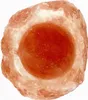 A close-up, top-down view of a pink salt candle holder with a red candle inside. Anteprima dell’immagine prodotto