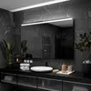 A modern bathroom vanity with a large illuminated mirror, sink, and accessories. Produktbild-Vorschau