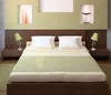 A bedroom scene with a bed, nightstands, and lamps. Produktbild-Vorschau