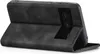 A black flip case for a smartphone, shown from the back with the case open and propped up. Produktbild-Vorschau