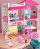 A dollhouse with furniture and accessories, set against a pink and white background. Voir les images du produit