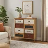 A dresser with multiple drawers of different colors and patterns, placed in a living room setting next to a sofa and a plant. Voir les images du produit