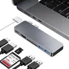 A USB-C hub and accessories are laid out next to a laptop. Voir les images du produit