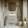 A modern bathroom vanity with a sink and mirror, decorated with towels and a spherical object. Náhled obrázku produktu