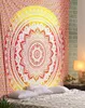A mandala tapestry is hung on a wall above a bed with pillows. Voir les images du produit
