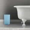 A light blue trash can is placed next to a white bathtub in a bathroom. Náhľad obrázku produktu