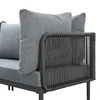 A close-up view of the armrest and cushions of a gray outdoor sofa. Voir les images du produit