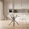 A modern kitchen with a round dining table and two transparent chairs. Anteprima dell’immagine prodotto